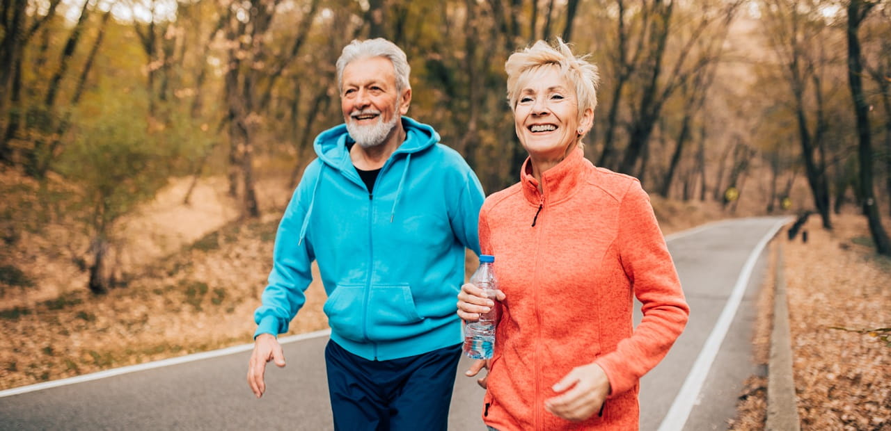 Senior couple exercise race walking in a park