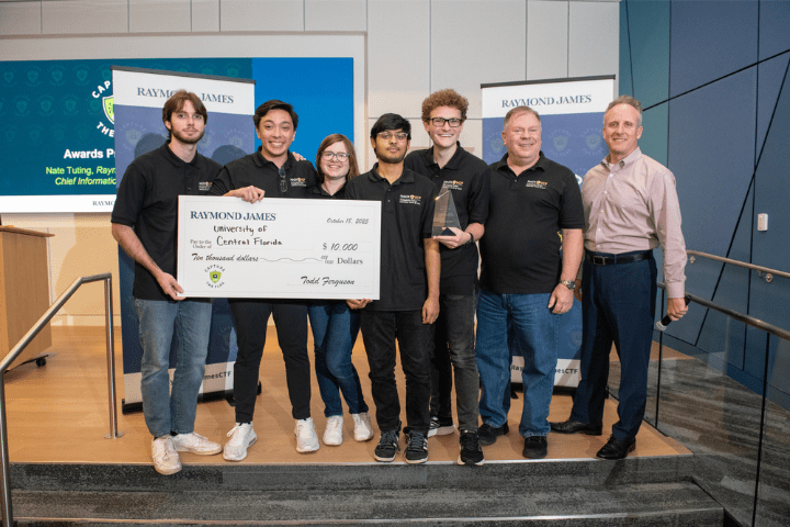 University of Central Florida students posing with their grand prize, a $10,000 check and award