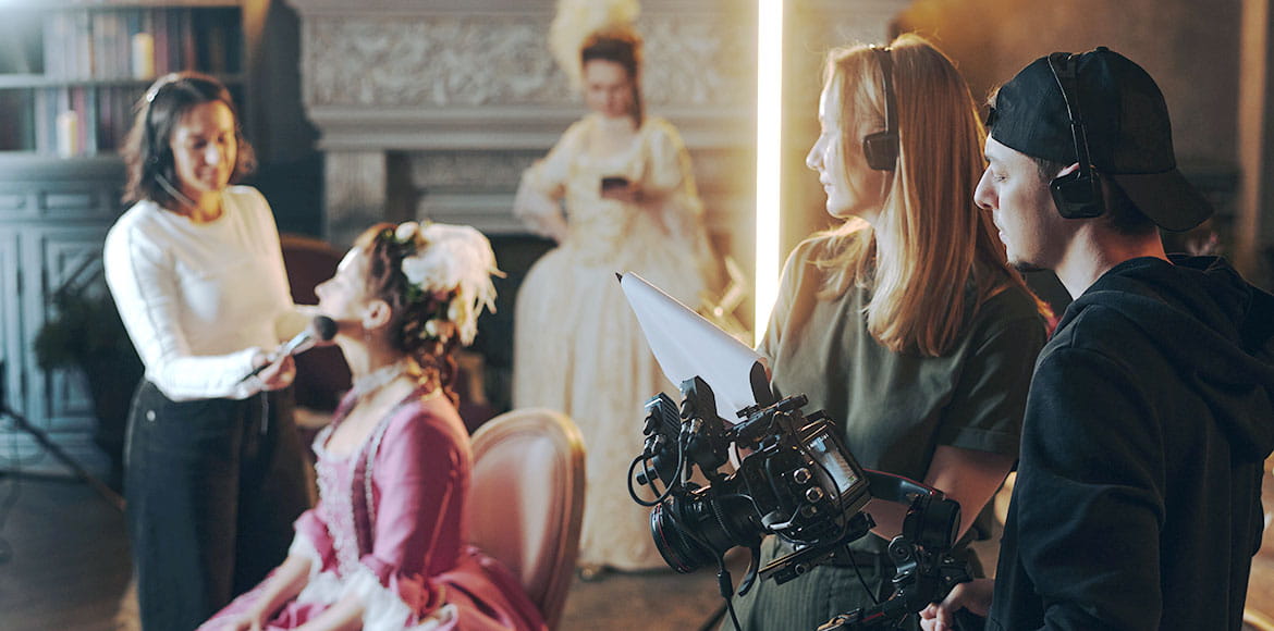 Young-Caucasian-Woman-Getting-Makeup-Applied-during-Baroque-Film-Production